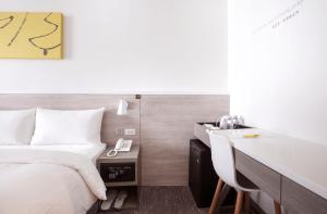 Letto o letti in una camera di CityInn Hotel Plus- Fuxing North Road Branch