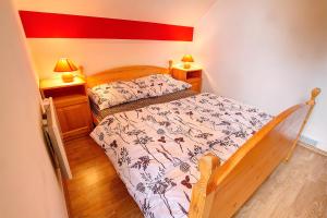 a small bedroom with a bed and two lamps at Apartment Sara in Vitanje