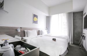 Letto o letti in una camera di CityInn Hotel Plus- Fuxing North Road Branch