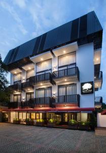 a large white building with a lot of windows at White Tree Residence in Jakarta
