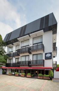 a building with solar panels on the side of it at White Tree Residence in Jakarta