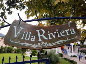 a sign that says lilla riviera hanging from a fence at Villa Riviera in Stavros