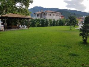 a large yard with a house and a gazebo at Villa Riviera in Stavros