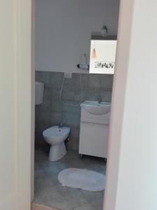 a bathroom with a toilet and a sink at Il corbezzolo in Linguaglossa