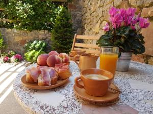 a table with a plate of food and a cup of coffee at Apartament Torrent de la Barruda in Vilallonga de Ter