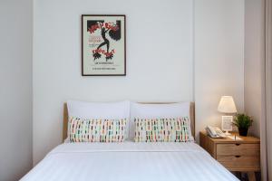 A bed or beds in a room at White Tree Residence