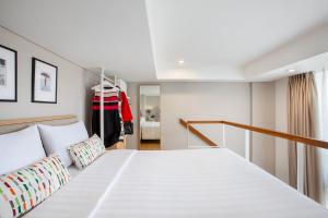 A bed or beds in a room at White Tree Residence
