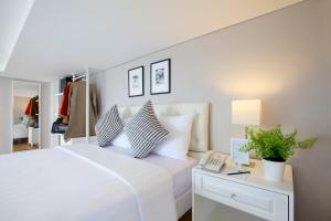 A bed or beds in a room at White Tree Residence