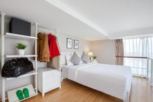 A bed or beds in a room at White Tree Residence