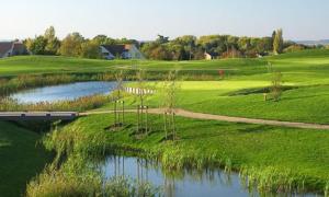 a golf course with a river and a bridge at Top Location apartment 10 min Disneyland in Bussy-Saint-Georges