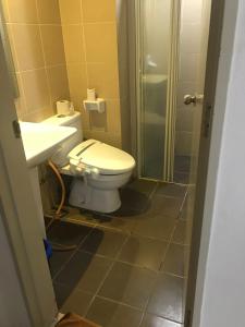 a bathroom with a toilet and a sink and a shower at Elegant Suites at Taragon Bukit Bintang in Kuala Lumpur