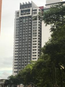 a tall building with a sign on top of it at Elegant Suites at Taragon Bukit Bintang in Kuala Lumpur