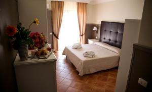 Voodi või voodid majutusasutuse Baia Di Ulisse Wellness & Spa toas
