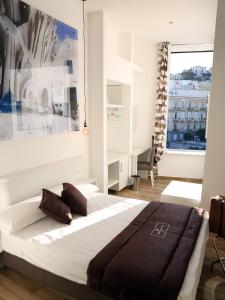 a bedroom with a bed and a large window at Dimora Diamante in Naples