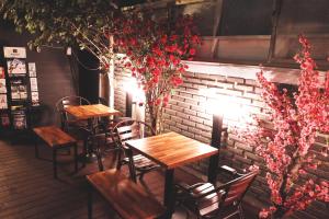 two tables and chairs in front of a brick wall at Must Stay Hotel Myeongdong in Seoul