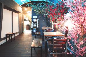 a restaurant with tables and chairs and flowers on the wall at Must Stay Hotel Myeongdong in Seoul