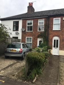 a car parked in front of a house at City Living in Norwich