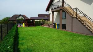 a yard with a playground next to a building at Villa Pati in Rewa