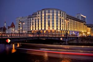 a bridge over a river in front of a building at Meliá Berlin in Berlin