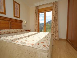 a bedroom with a bed and a large window at La Higuera in Güéjar-Sierra +36 photos