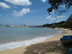 a view of a beach with the ocean at Chamod Holiday Home in Tangalle