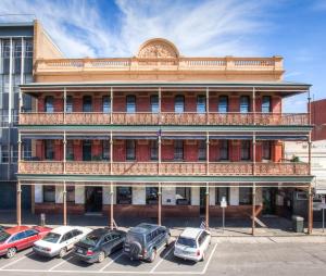 a large building with a clock on the front of it at Quality Inn The George Hotel Ballarat in Ballarat