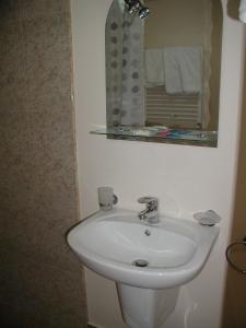 a bathroom with a white sink and a mirror at Hotel Grig in Yerevan