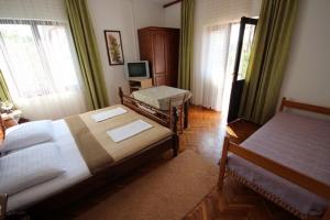 Un pat sau paturi într-o cameră la Apartments & Rooms Luka