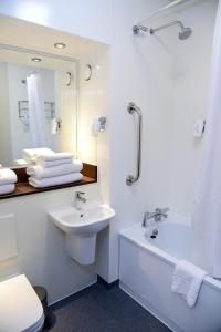 a bathroom with a sink and a toilet and a mirror at Lock Keeper, Worksop by Marston's Inns in Worksop