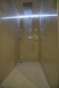 a bathroom with a shower with a glass door at Anna Hotel in Budapest