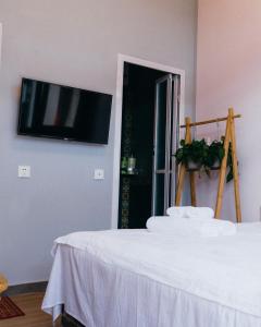 a room with a bed and a flat screen tv on a wall at Chez Ina & Jasee in Miyun