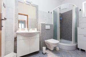 a bathroom with a sink and a toilet and a shower at Apartments Ksenija in Stomorska +71 photos