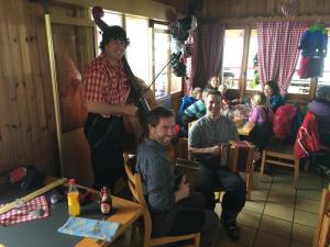 a group of people sitting at a table in a room at Restaurant Fleschboden in Rosswald