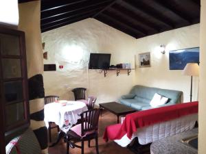 een woonkamer met een bank en een tafel bij Casa Dos Barrancos in Santa Cruz de Tenerife