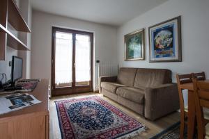 a living room with a couch and a window at Chalet Santa Barbara in Bormio