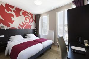 a bedroom with a bed with a red and white wall at Hotel Bastille in Paris