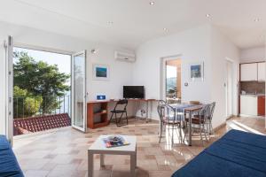 a living room with a couch and a table at Apartments Ksenija in Stomorska