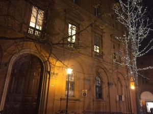 a building with a christmas tree in front of it at BLQ 01boutique B&B in Bologna