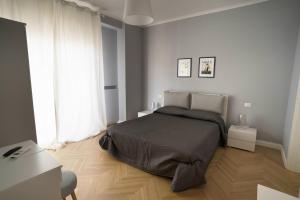 a bedroom with a large bed and a window at Room 56 in Bari
