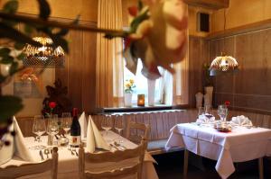 ein Esszimmer mit zwei Tischen mit weißen Tischdecken in der Unterkunft Hotel Kolb in Zeil