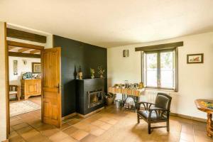 a living room with a fireplace and a table and chairs at Posada La Charola in Lamadrid