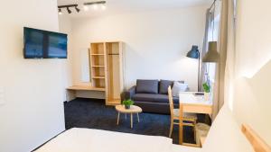 a living room with a couch and a table at Hotel Rhönhof in Hünfeld