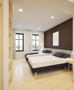 a bedroom with two beds and a couch at SleepWell Apartments in Legnica