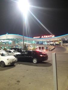 a group of cars parked in a parking lot under a street light at Apartments Ahmetova 6 32 in Almaty