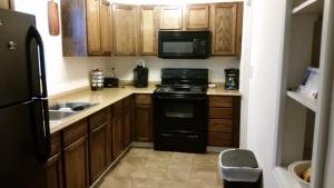 a kitchen with a black stove and a microwave at 1551 Sturm Ave in Indianapolis