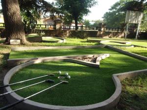 a miniature golf course with balls on the grass at Cabañas EL CASTILLO in Villa del Dique
