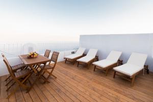 a group of chairs and a table on a balcony at Angeli a Ravello in Ravello
