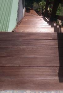 a set of wooden stairs leading up to a building at Les Alizés du Nord in Anse-Bertrand