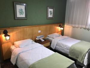 Habitación de hotel con 2 camas y 2 lámparas en Residencial Pantanal Chácara Klabin, en São Paulo