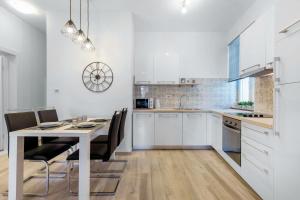 a kitchen with a table and chairs in a room at Central Suite Rijeka in Rijeka